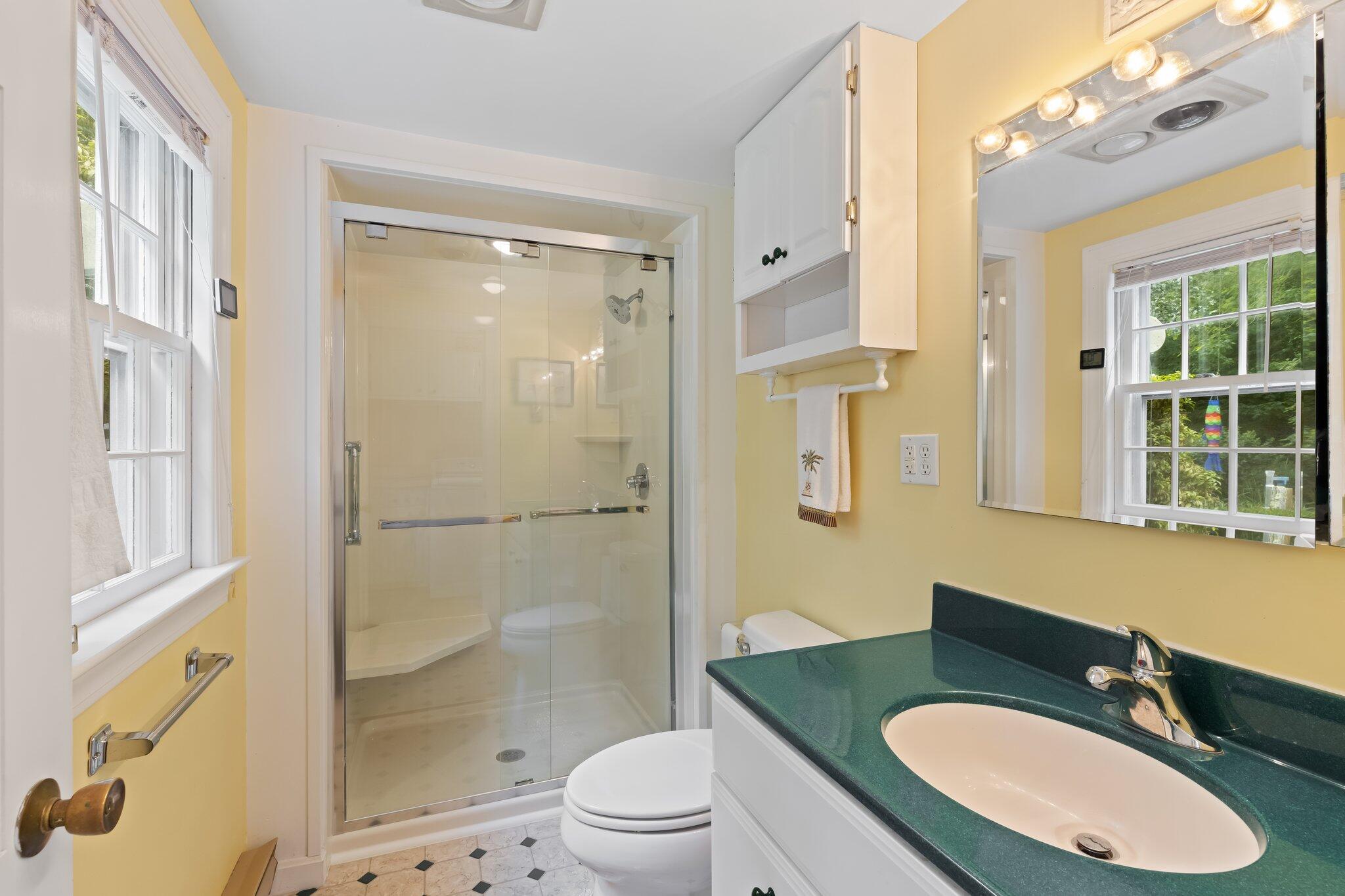 152 Monument Road Orleans, MA 02653 - Photo 24 of 40 a bathroom with a sink toilet a mirror and shower
