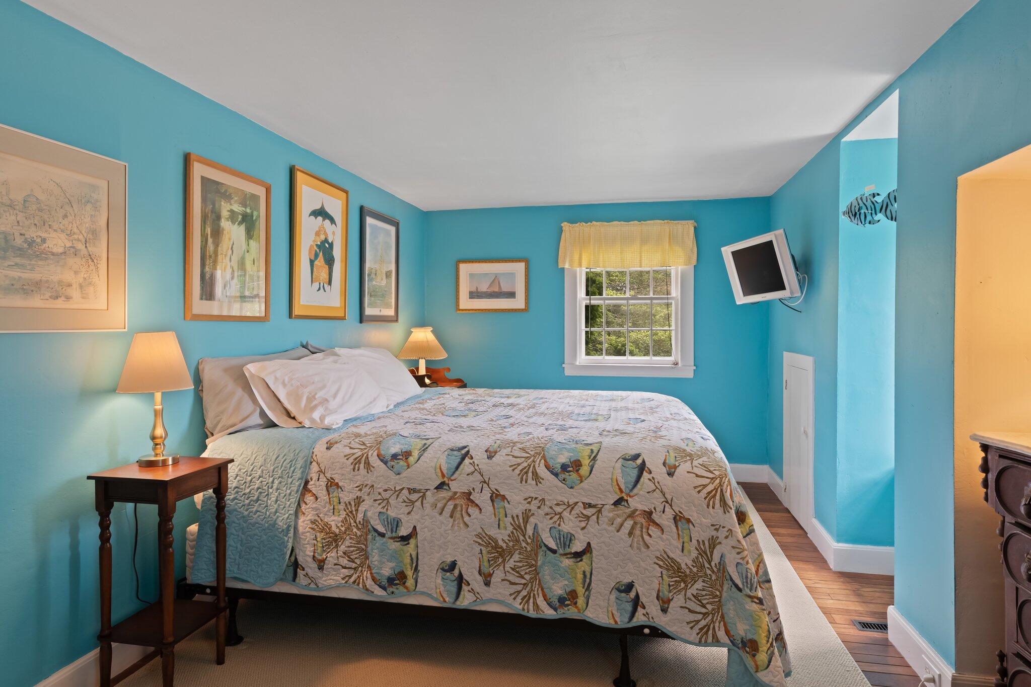 152 Monument Road Orleans, MA 02653 - Photo 28 of 40 a bedroom with a bed and wooden floor