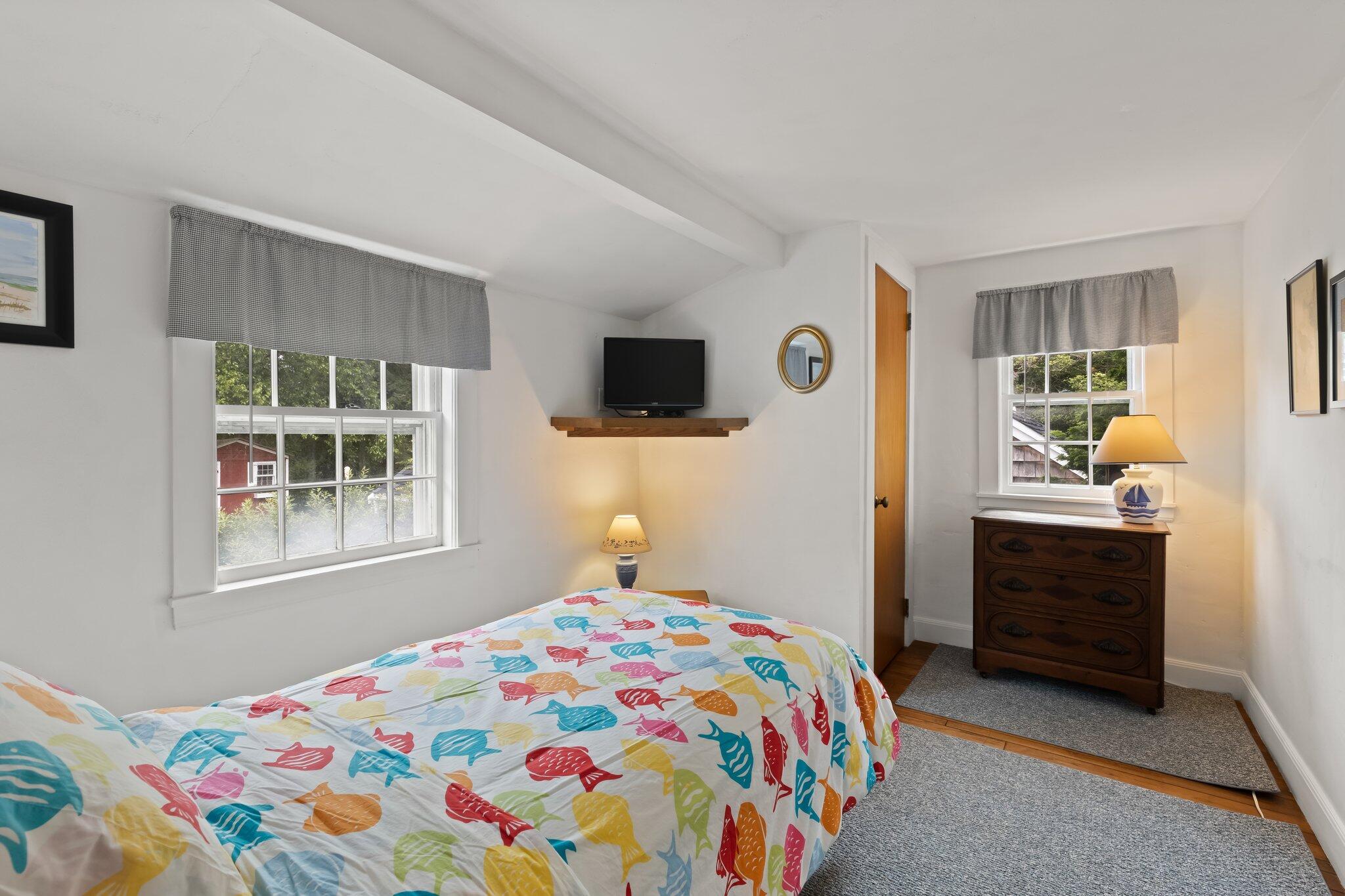 152 Monument Road Orleans, MA 02653 - Photo 30 of 40 a bedroom with a bed and a window