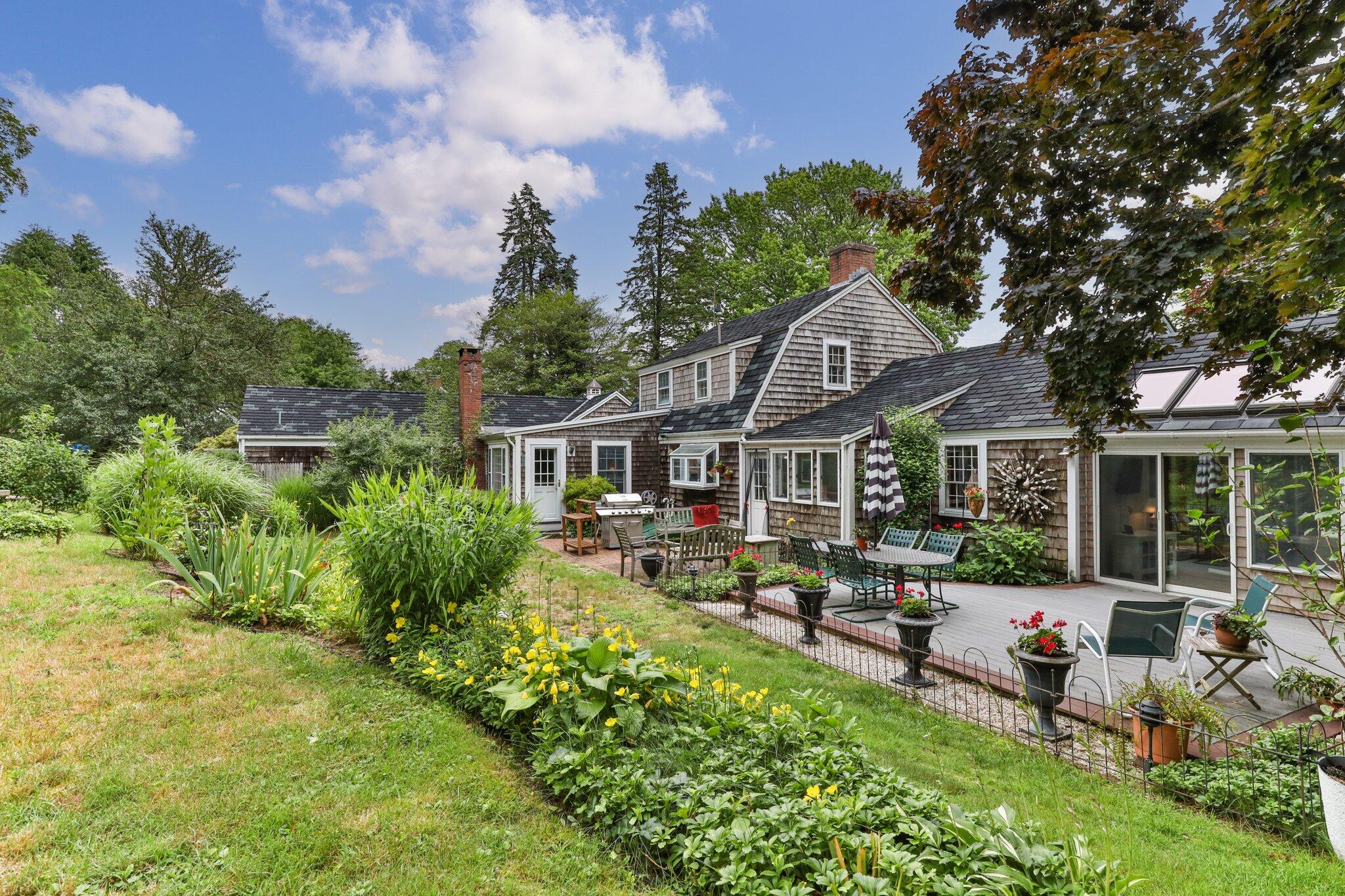 152 Monument Road Orleans, MA 02653 - Photo 33 of 40 a front view of a house with garden and trees