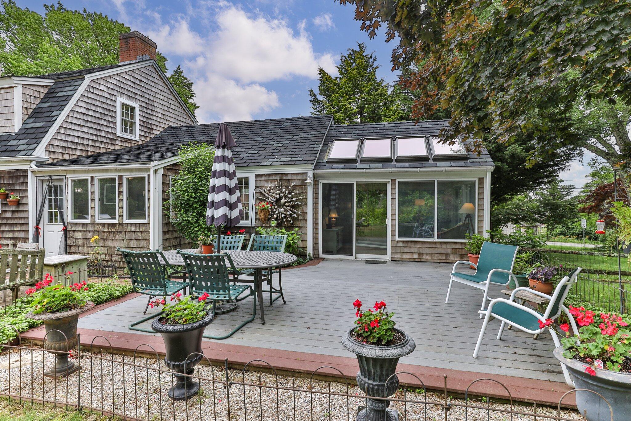152 Monument Road Orleans, MA 02653 - Photo 34 of 40 a house view with a seating space and garden