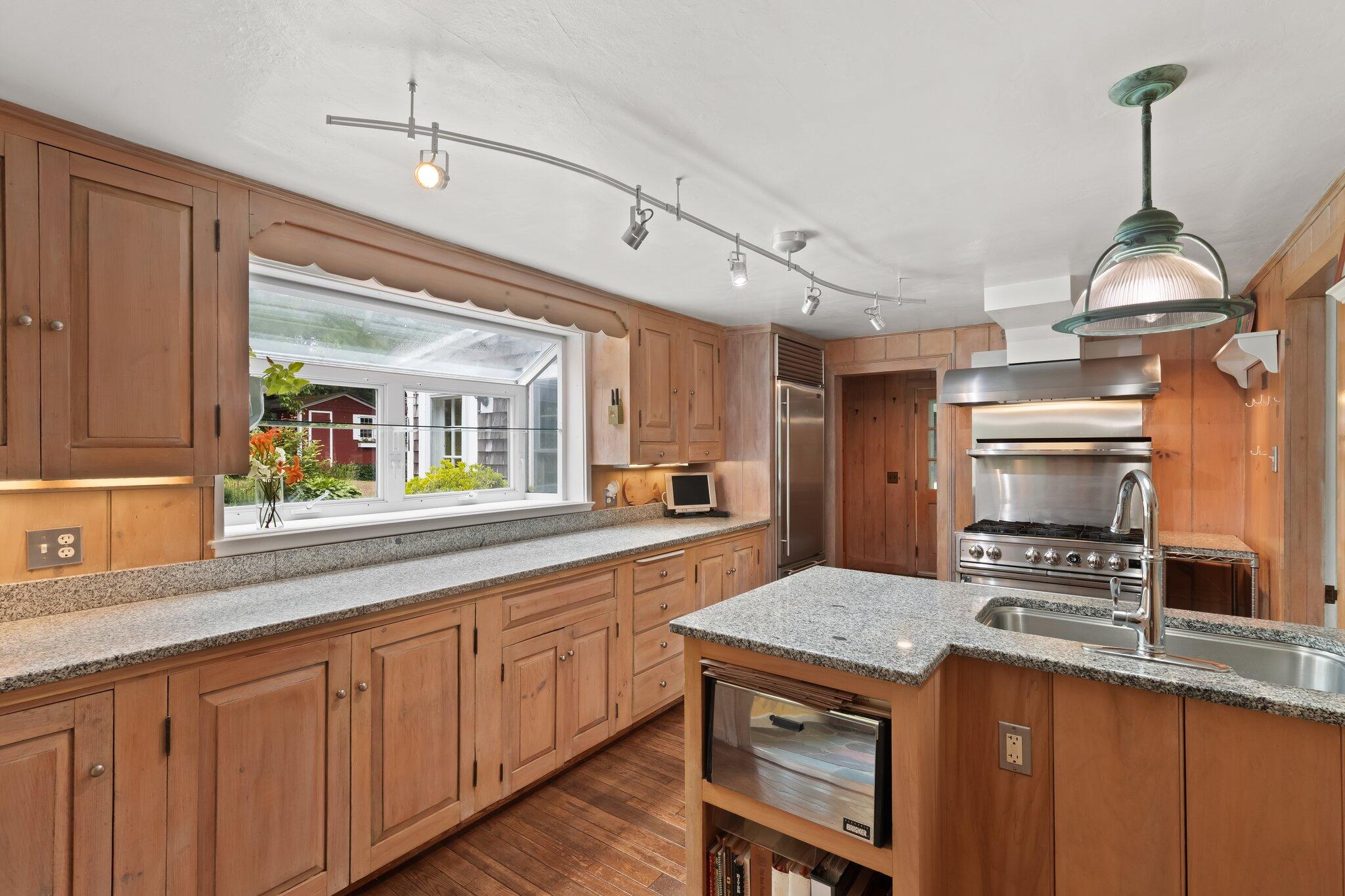 152 Monument Road Orleans, MA 02653 - Photo 4 of 40 a kitchen with sink cabinets and wooden floor