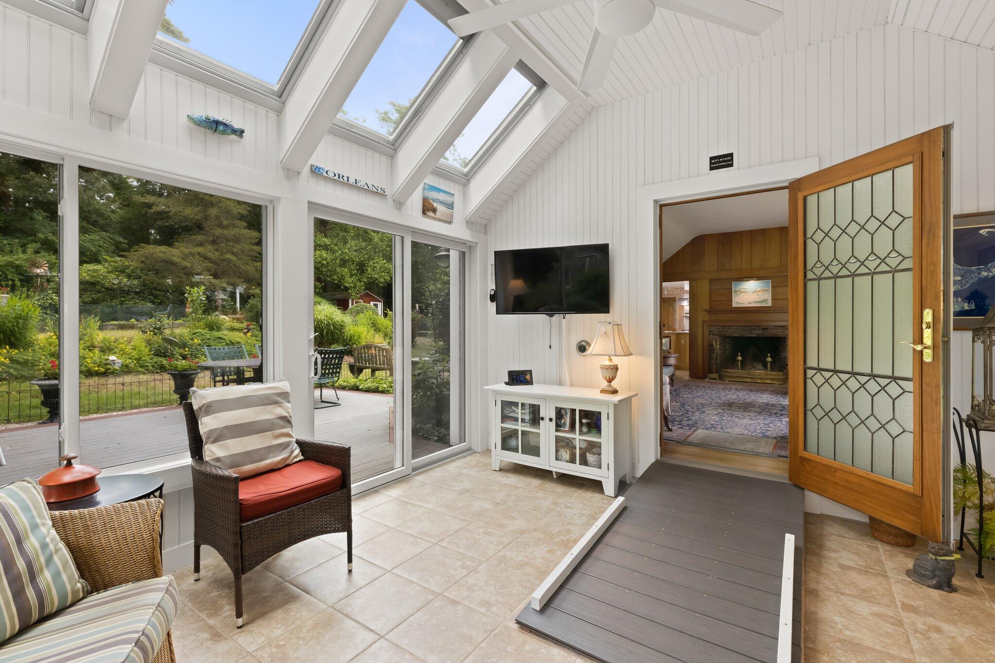 152 Monument Road Orleans, MA 02653 - Photo 9 of 40 a living room with furniture and a flat screen tv