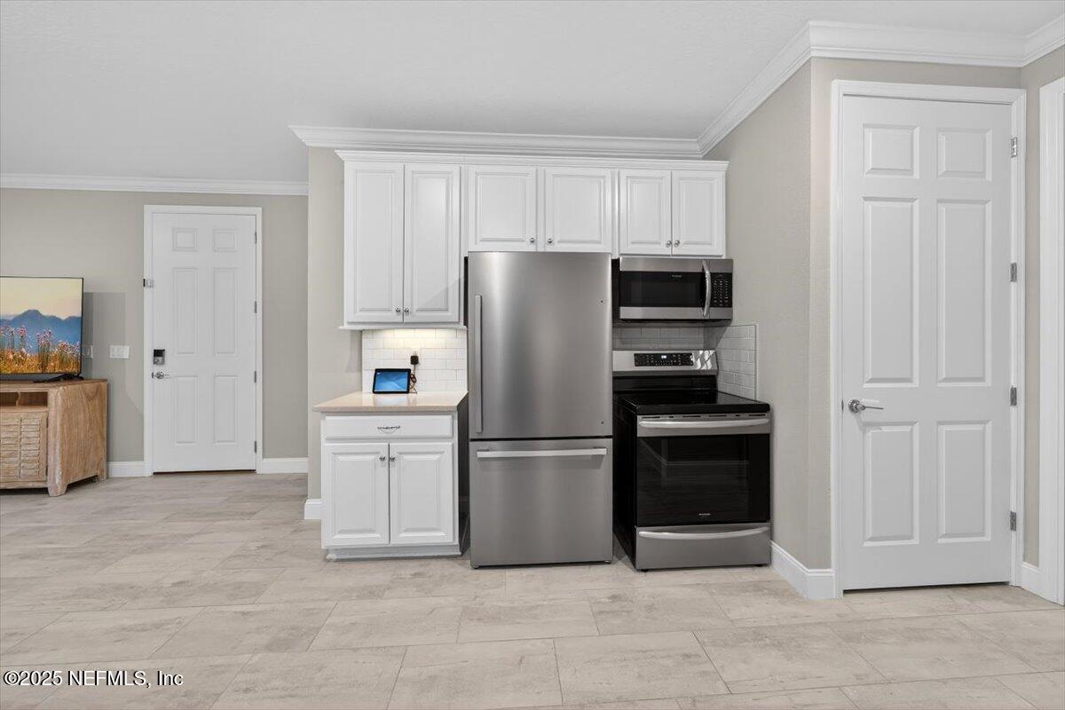 178 Antolin Way St. Augustine, FL 32095 - Photo 19 of 107 a kitchen with stainless steel appliances a refrigerator and white cabinets