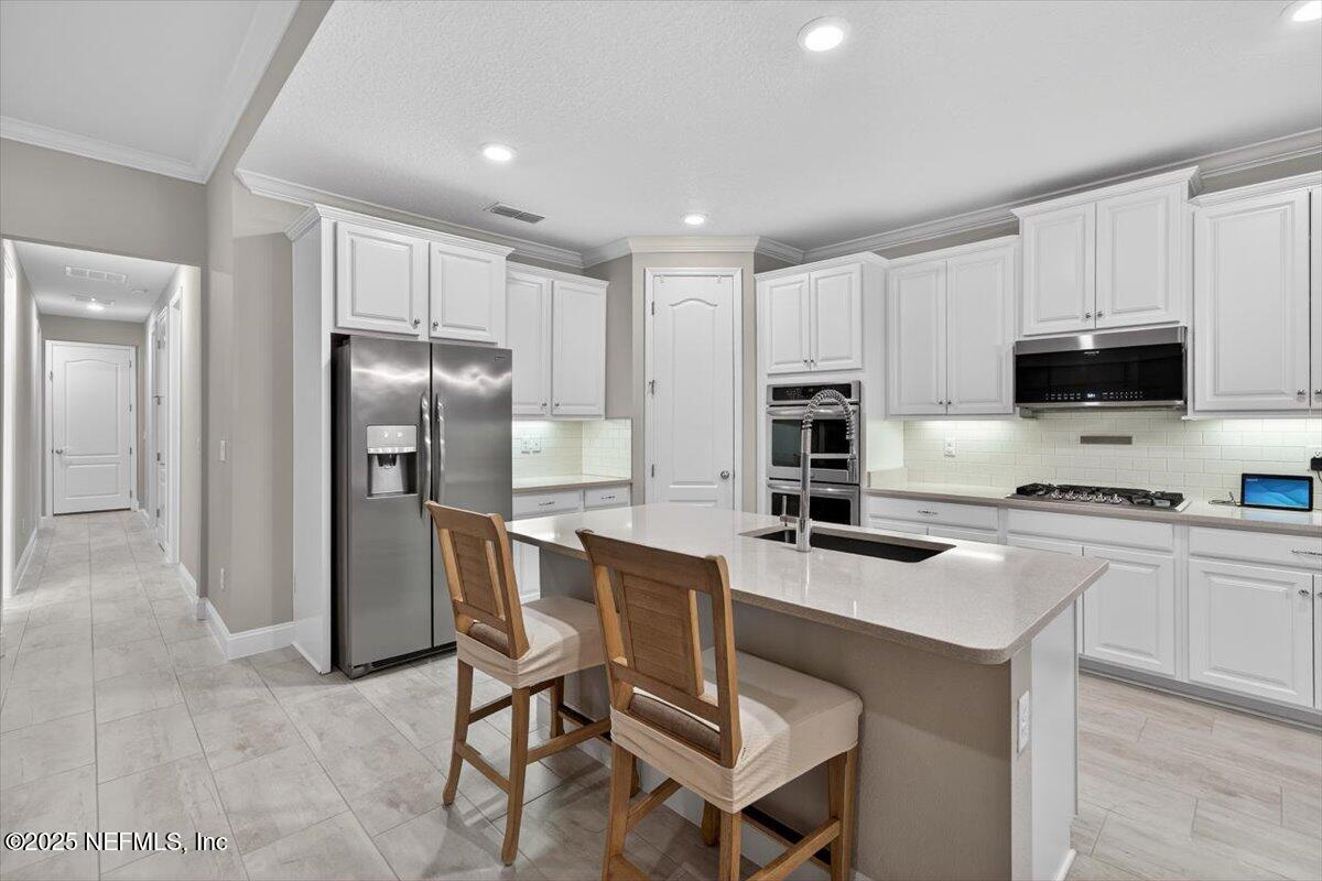 178 Antolin Way St. Augustine, FL 32095 - Photo 20 of 107 a kitchen with stainless steel appliances a refrigerator stove microwave and sink