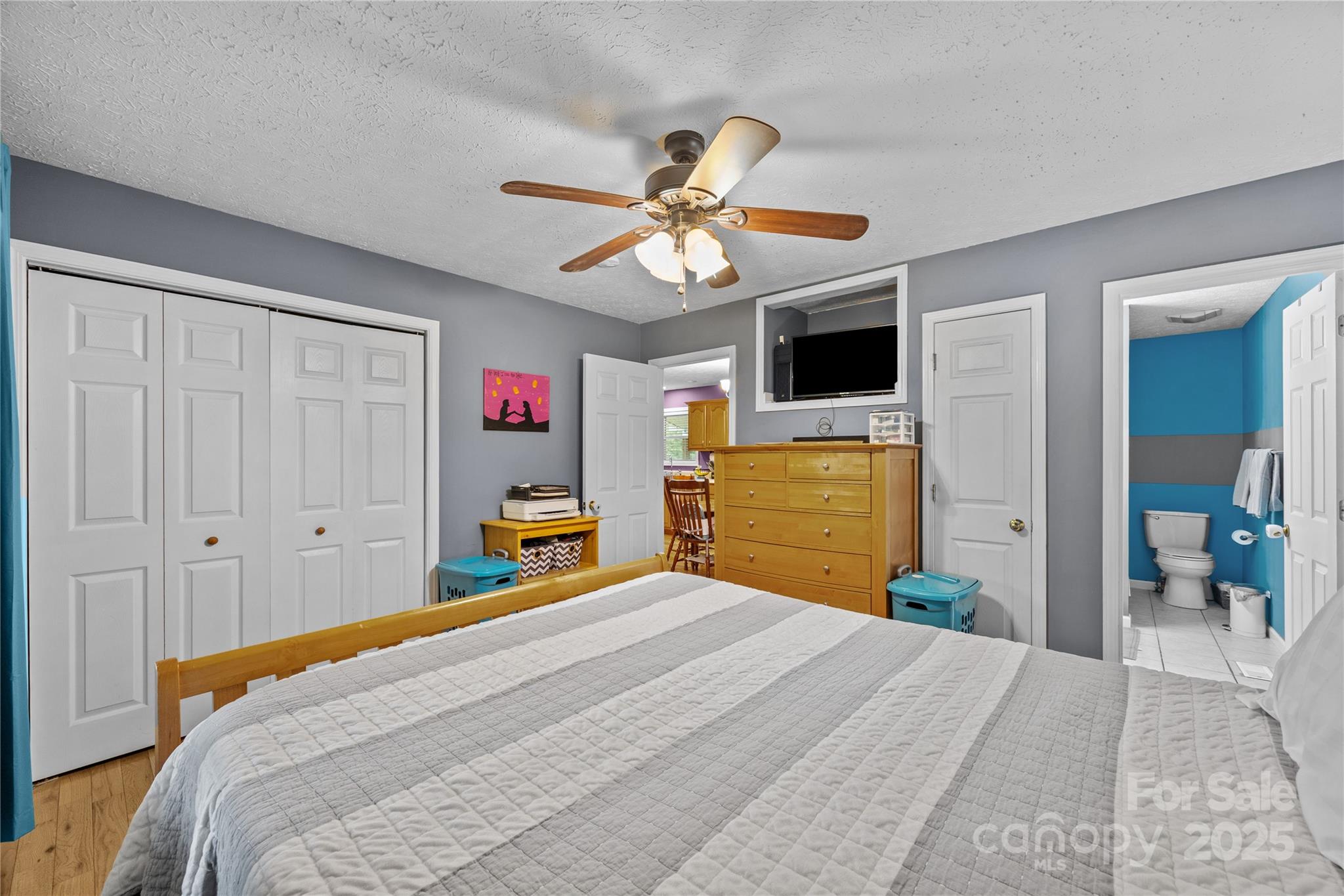 72 Sovereign Circle Clyde, NC 28721 - Photo 13 of 21 a bedroom with a bed and a chandelier