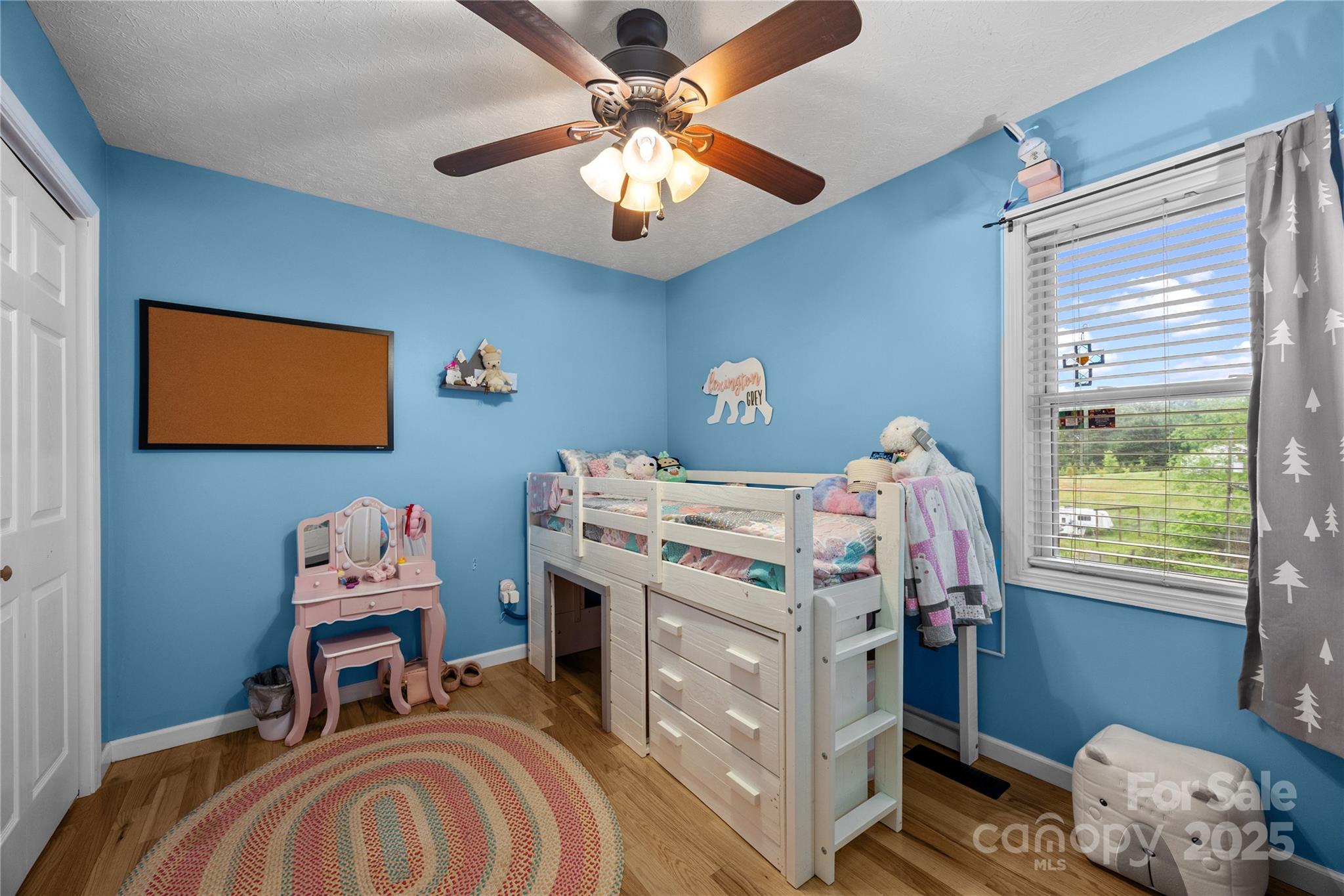 72 Sovereign Circle Clyde, NC 28721 - Photo 15 of 21 a bedroom with a bed and a chandelier