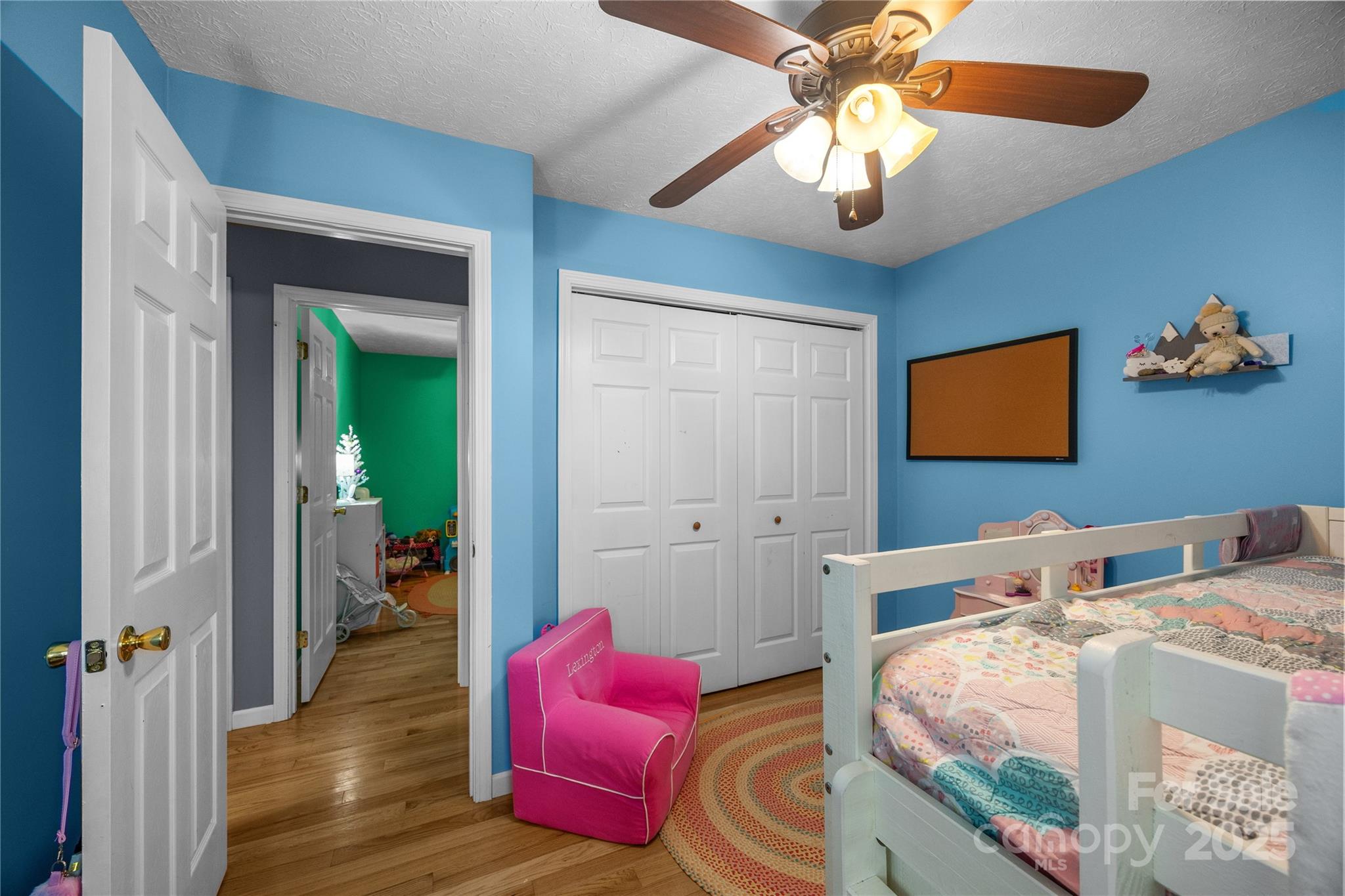 72 Sovereign Circle Clyde, NC 28721 - Photo 16 of 21 a bed room with a bed and a chandelier