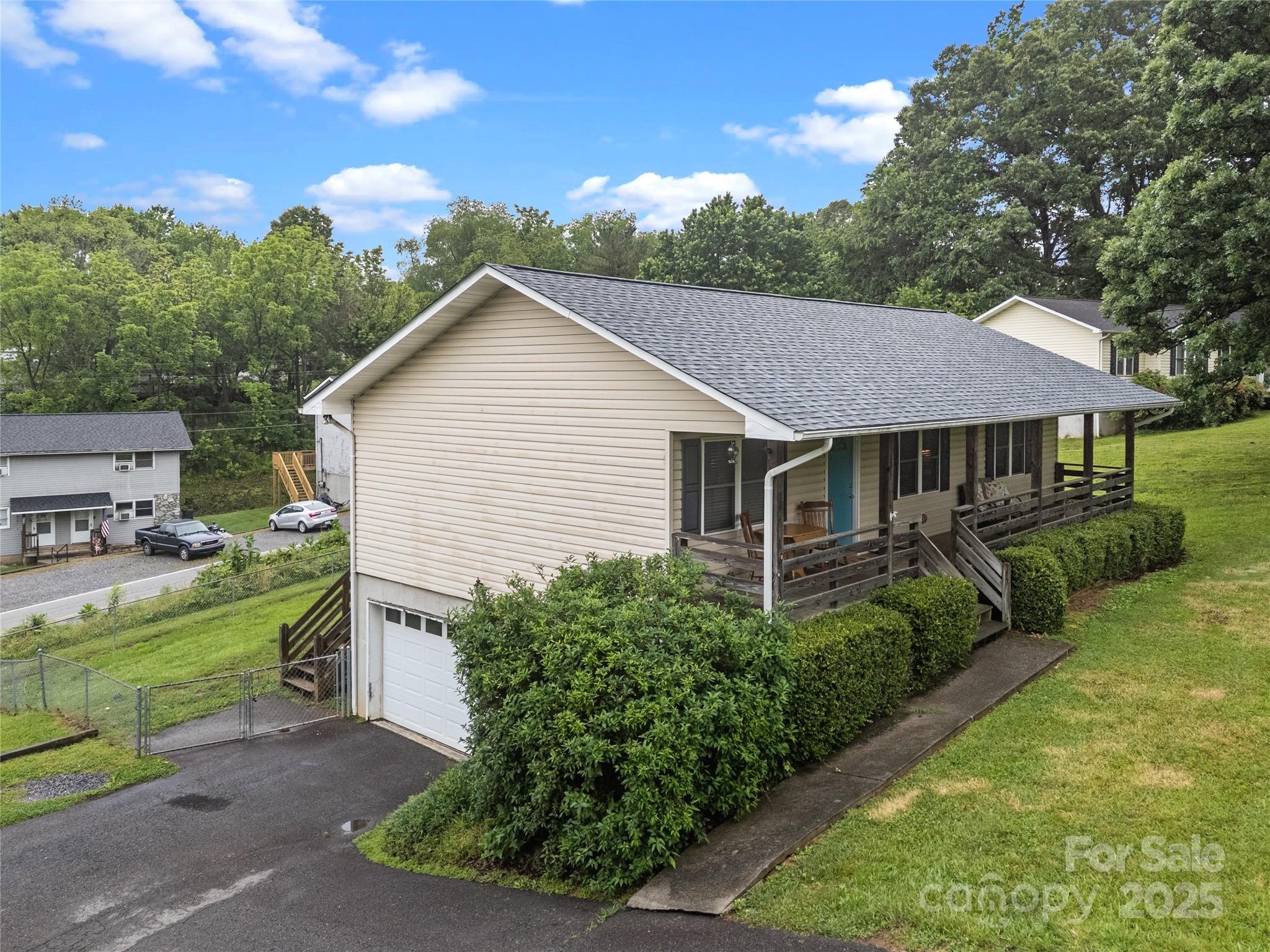 72 Sovereign Circle Clyde, NC 28721 - Photo 2 of 21 a view of a house with a yard plants and large tree