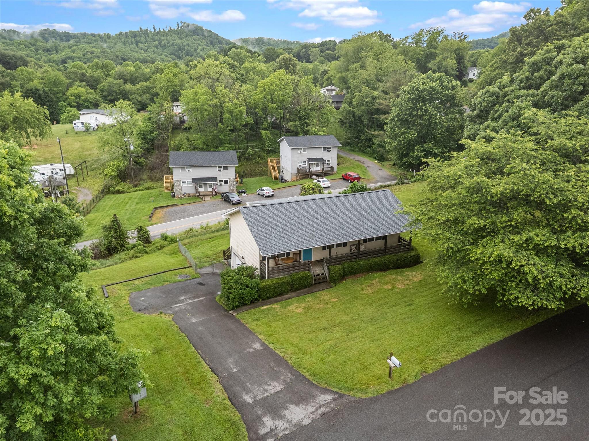 72 Sovereign Circle Clyde, NC 28721 - Photo 3 of 21 a view of a swimming pool with a yard and large trees