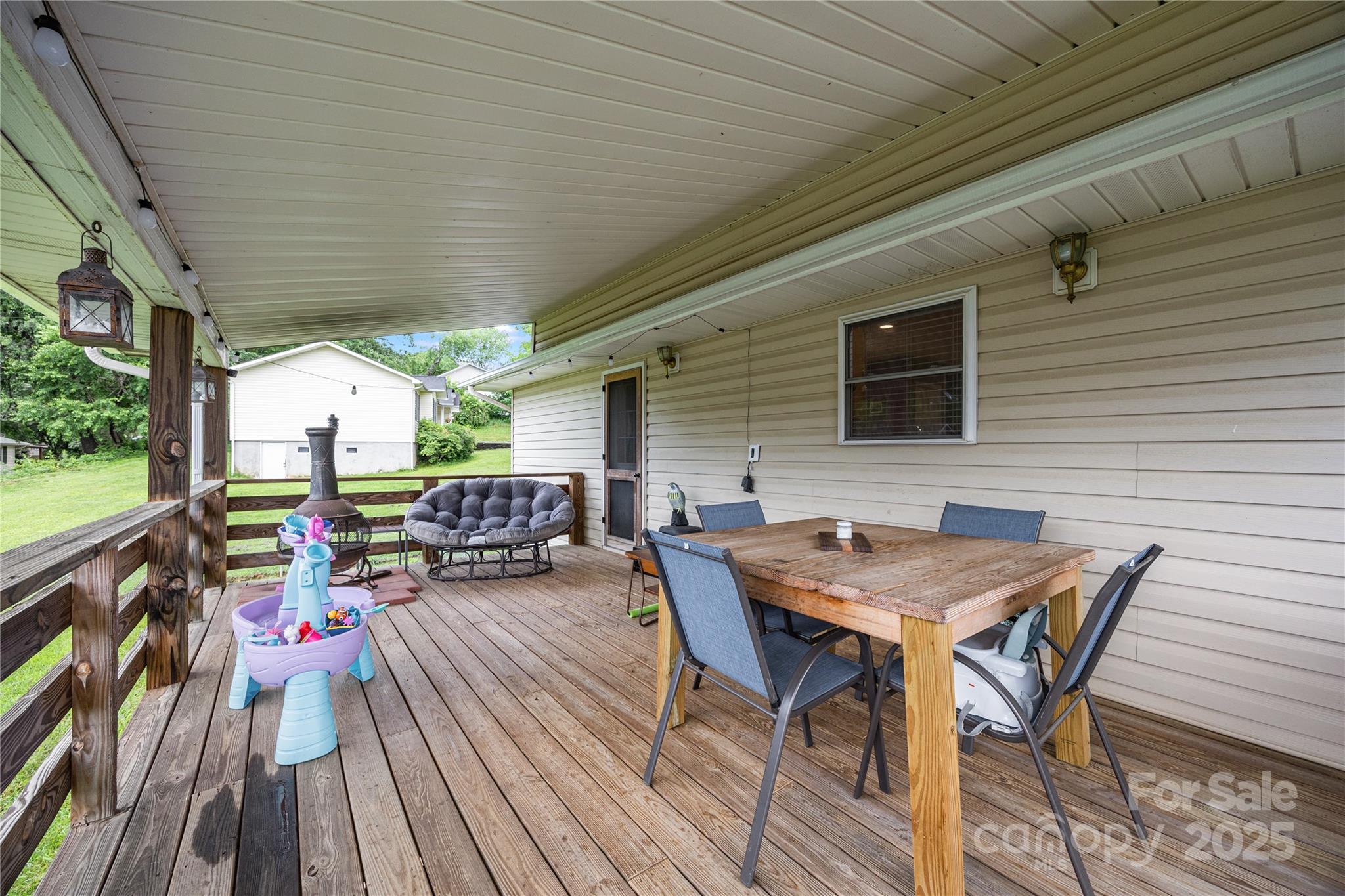 72 Sovereign Circle Clyde, NC 28721 - Photo 5 of 21 a backyard of a house with wooden floor outdoor seating and yard in the back