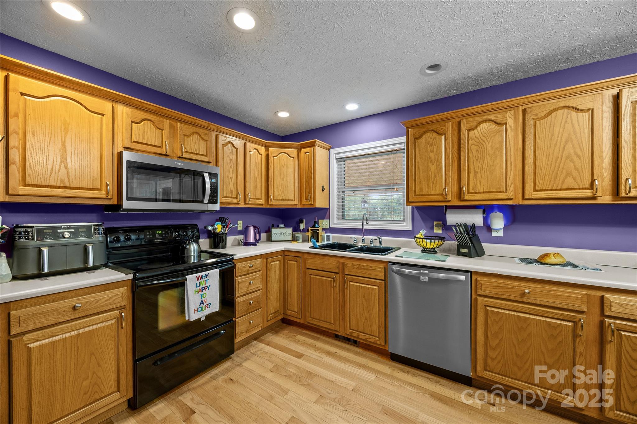72 Sovereign Circle Clyde, NC 28721 - Photo 10 of 21 a kitchen with stainless steel appliances granite countertop wooden cabinets and a stove top oven