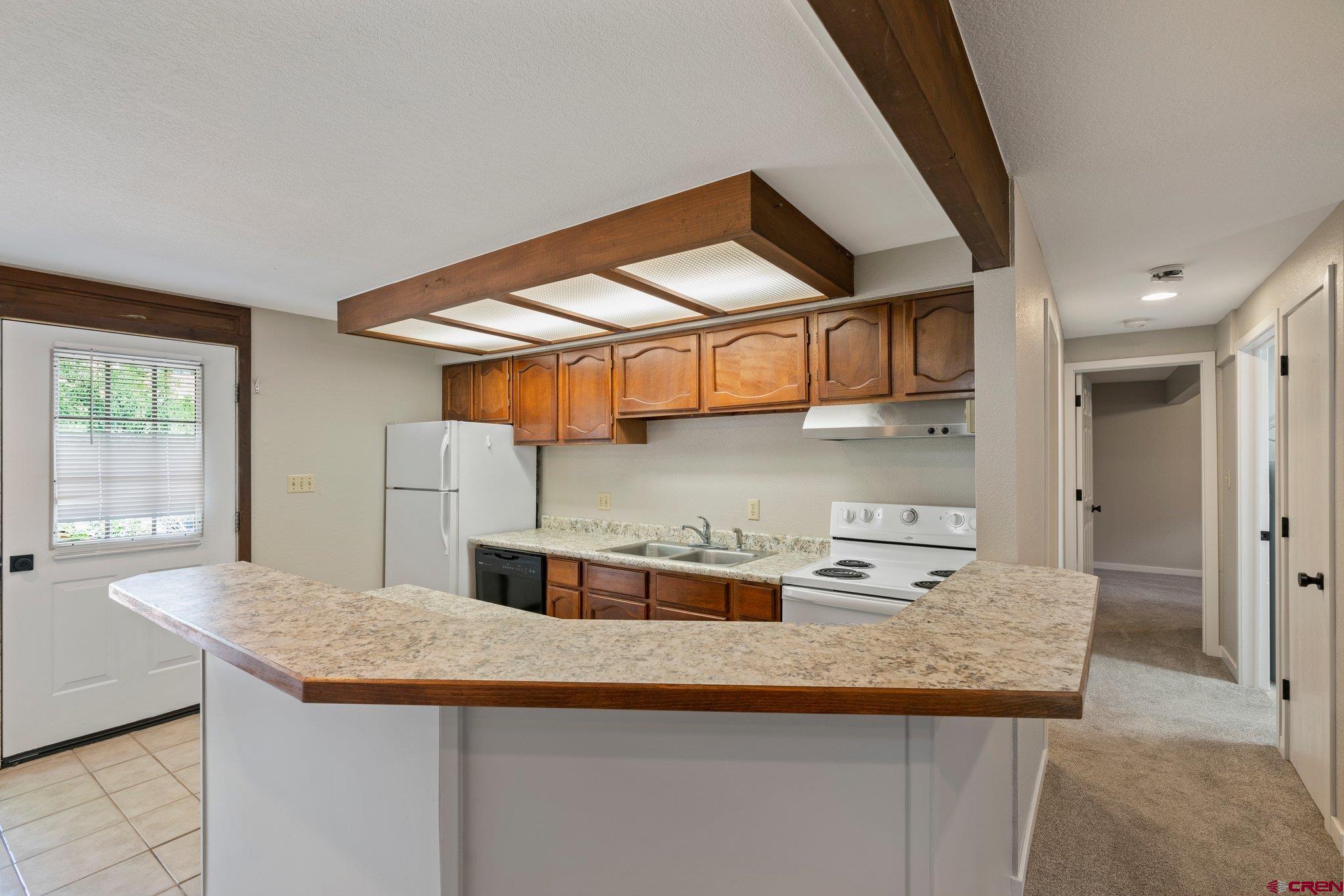 2913 Richard Drive Durango, CO 81301 - Photo 19 of 35 a kitchen with stainless steel appliances granite countertop a sink and a refrigerator