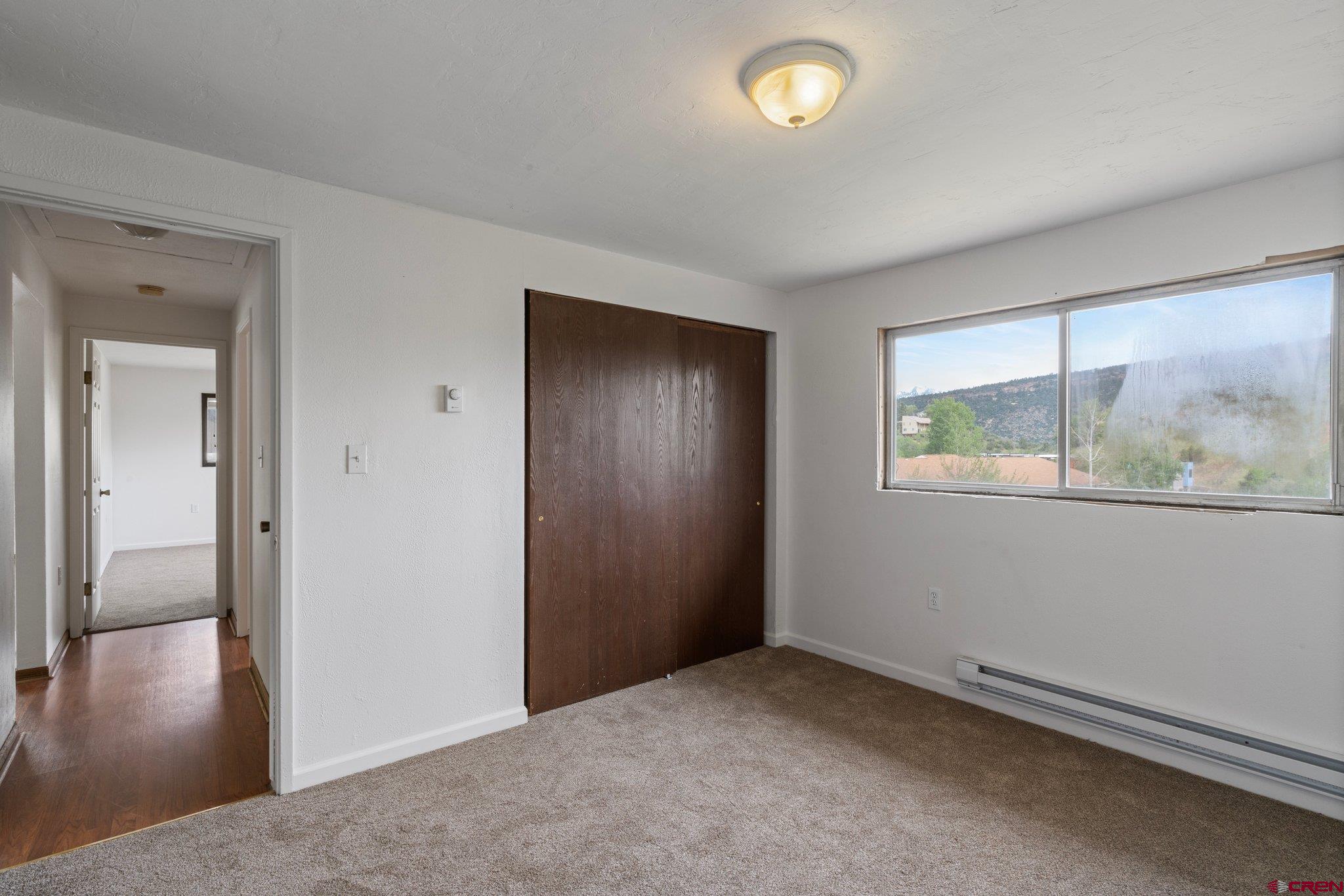 2913 Richard Drive Durango, CO 81301 - Photo 20 of 35 an empty room with wooden floor and windows
