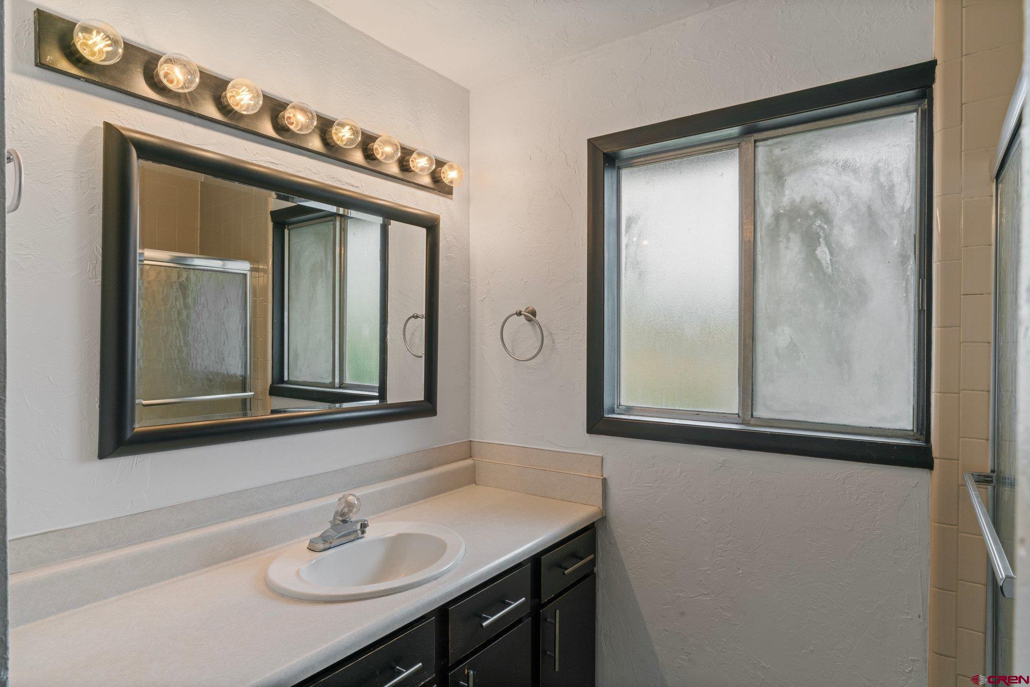 2913 Richard Drive Durango, CO 81301 - Photo 25 of 35 a bathroom with a sink a mirror and a vanity