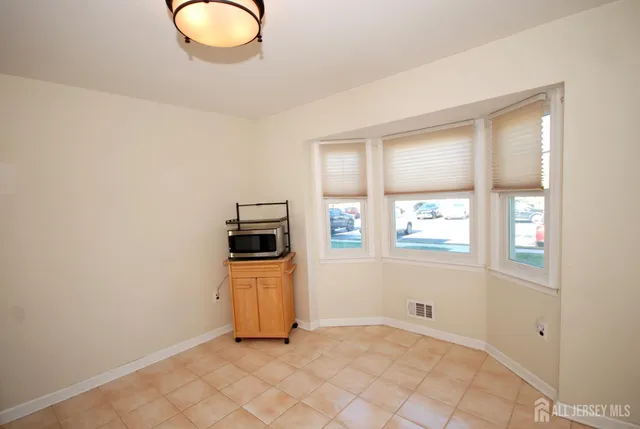 a bathroom with a granite countertop toilet a sink and a mirror