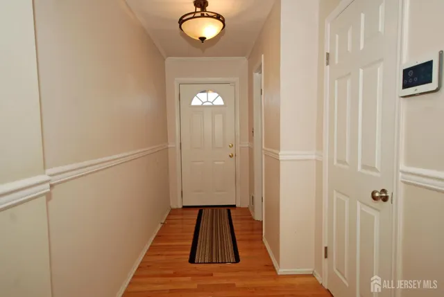 a view of a hallway with wooden floor
