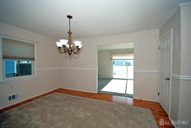 a view of a kitchen with microwave and window