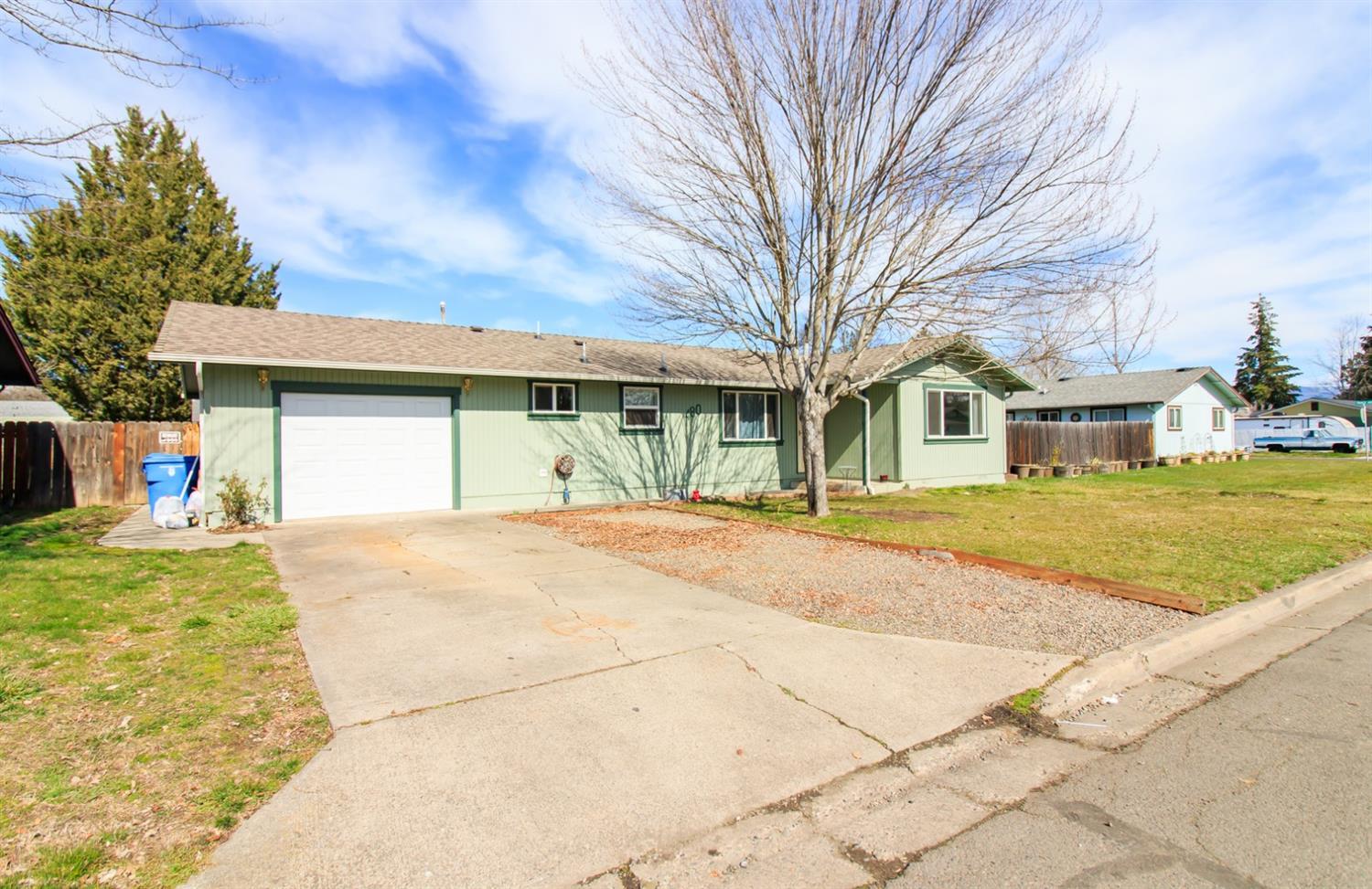 480 Elm Way Eagle Point, OR 97524 - Photo 2 of 26 a front view of a house with a yard and garage