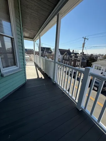 a view of a balcony with wooden floor