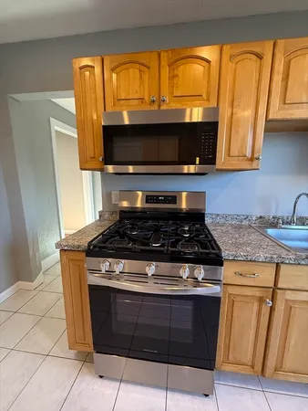 a stove top oven sitting inside of a kitchen