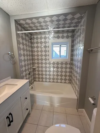 a bathroom with a bathtub and shower