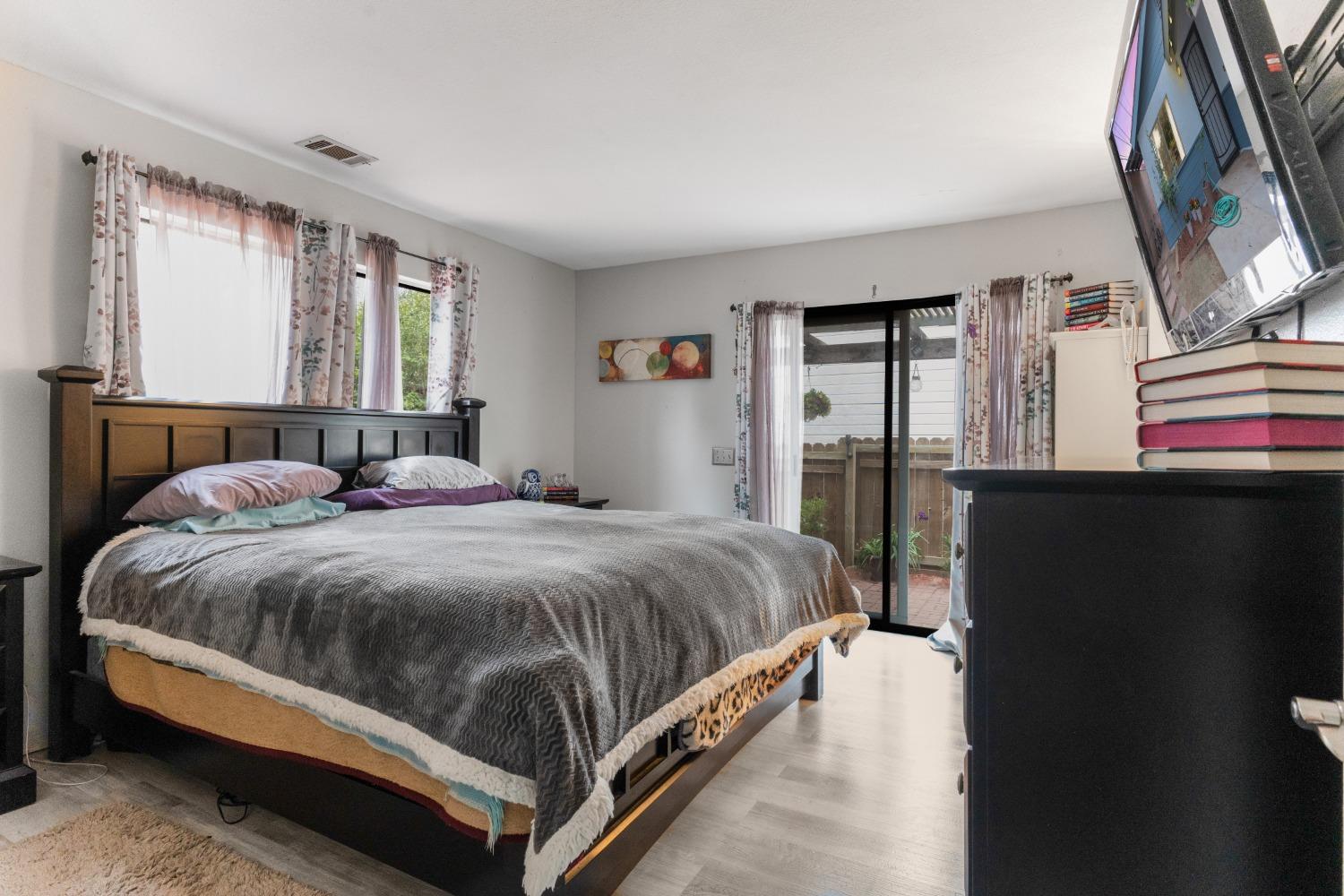 232 Prospect Street Oak View, CA 93022 - Photo 11 of 33 a bedroom with a bed lamp closet a mirror and a window