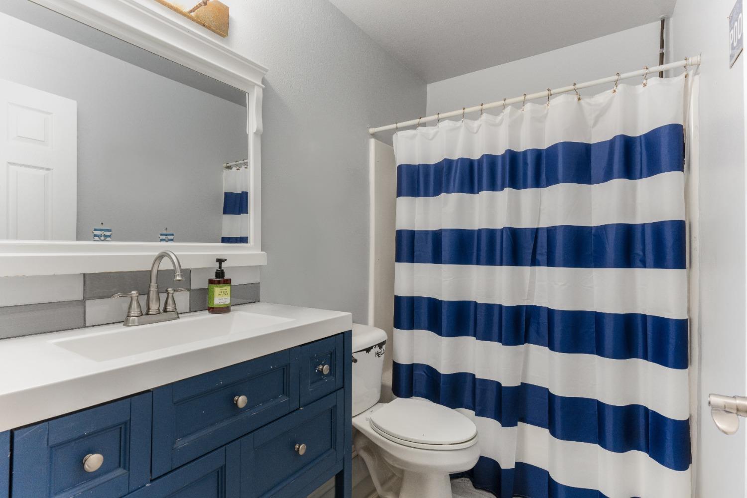 232 Prospect Street Oak View, CA 93022 - Photo 18 of 33 a bathroom with a sink a toilet a shower and a mirror