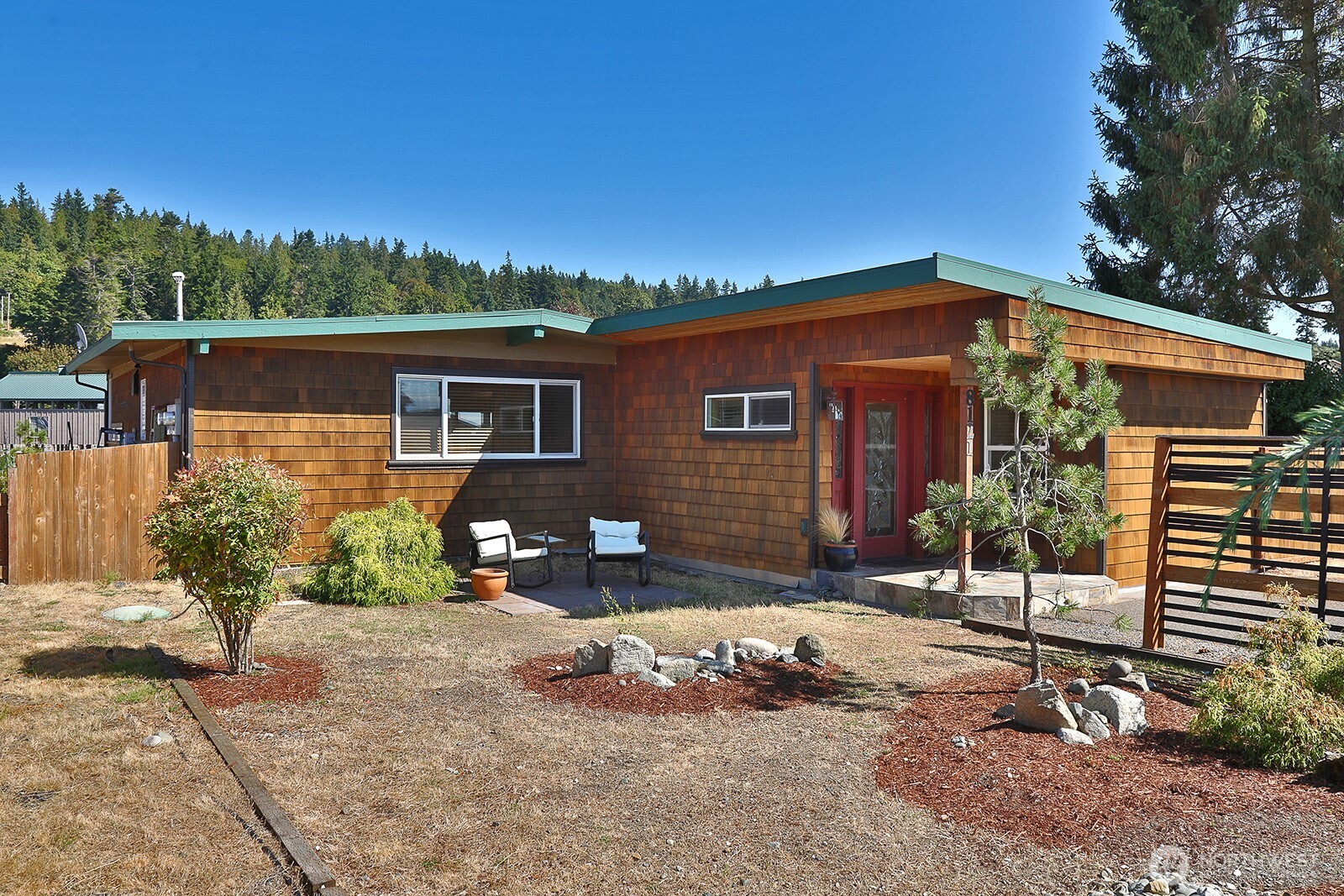 8121 Sandy Hook Terrace Clinton, WA 98236 - Photo 1 of 40 a front view of a house with a yard