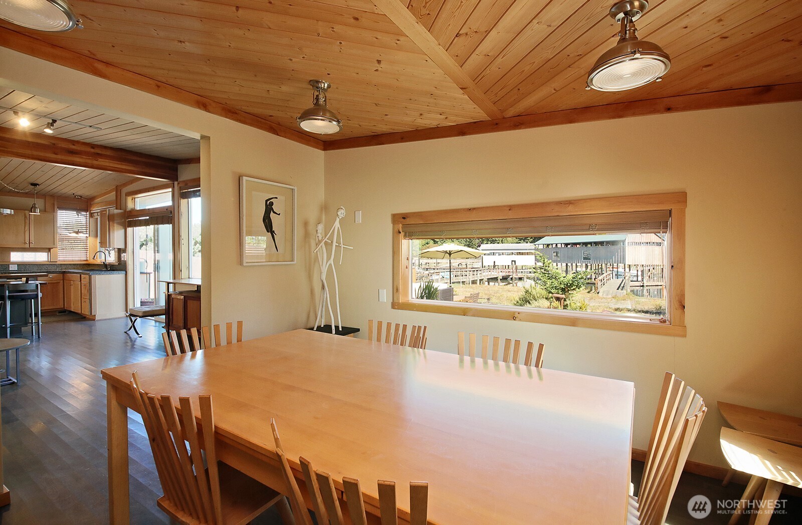 8121 Sandy Hook Terrace Clinton, WA 98236 - Photo 13 of 40 a view of a dining room with furniture wooden floor and chandelier