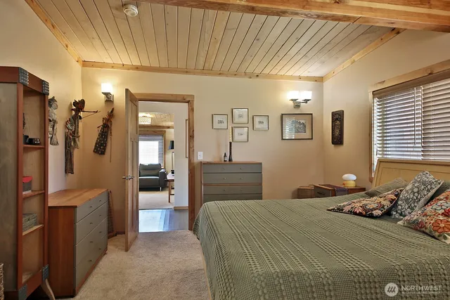 a bedroom with a bed and a view of bathroom