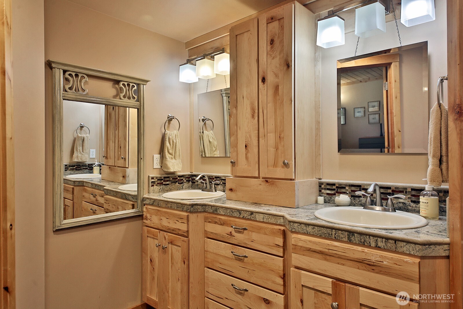 8121 Sandy Hook Terrace Clinton, WA 98236 - Photo 18 of 40 a bathroom with a granite countertop sink and a mirror