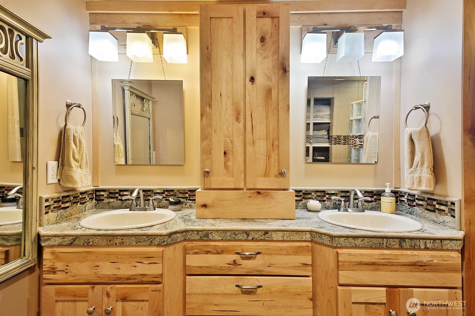 8121 Sandy Hook Terrace Clinton, WA 98236 - Photo 19 of 40 a bathroom with a granite countertop sink and a mirror