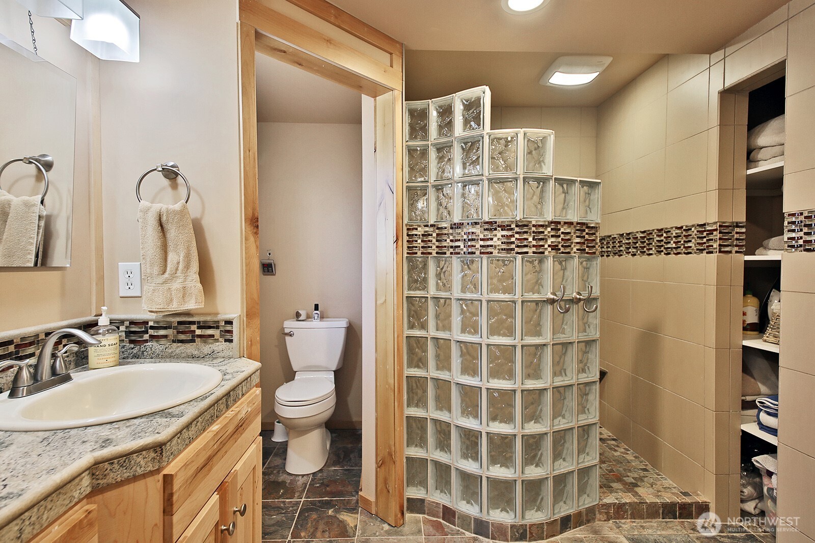 8121 Sandy Hook Terrace Clinton, WA 98236 - Photo 20 of 40 a bathroom with a double vanity sink toilet and shower