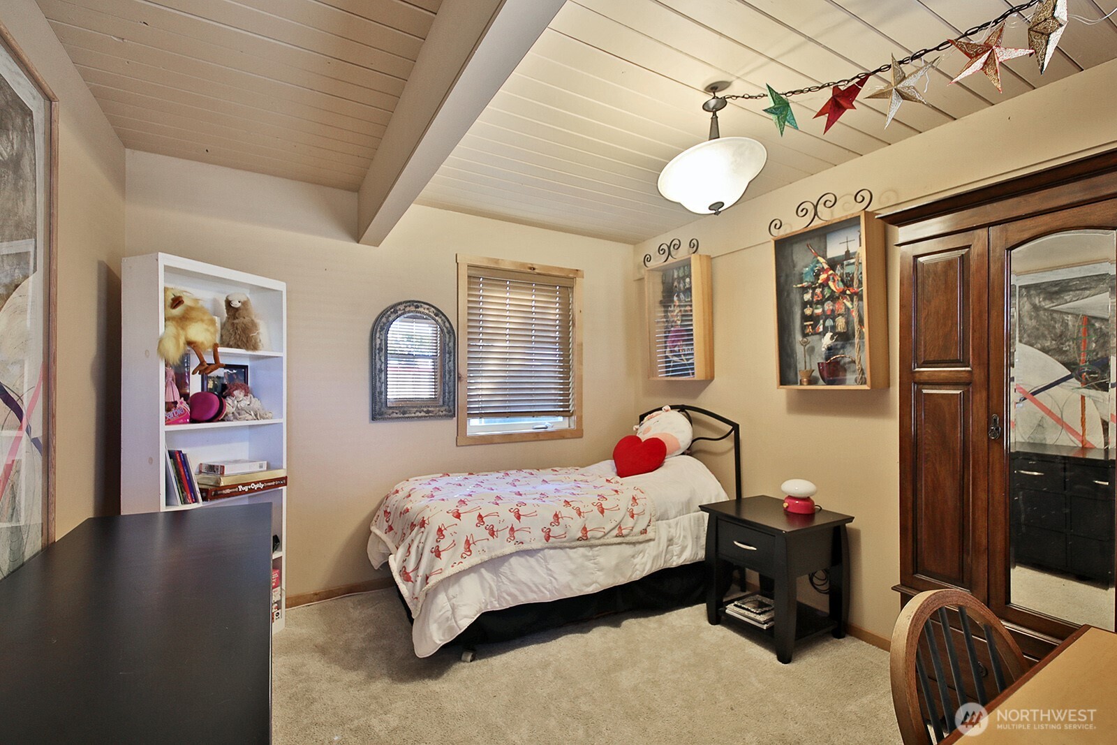 8121 Sandy Hook Terrace Clinton, WA 98236 - Photo 21 of 40 a bedroom with a bed and wooden floor