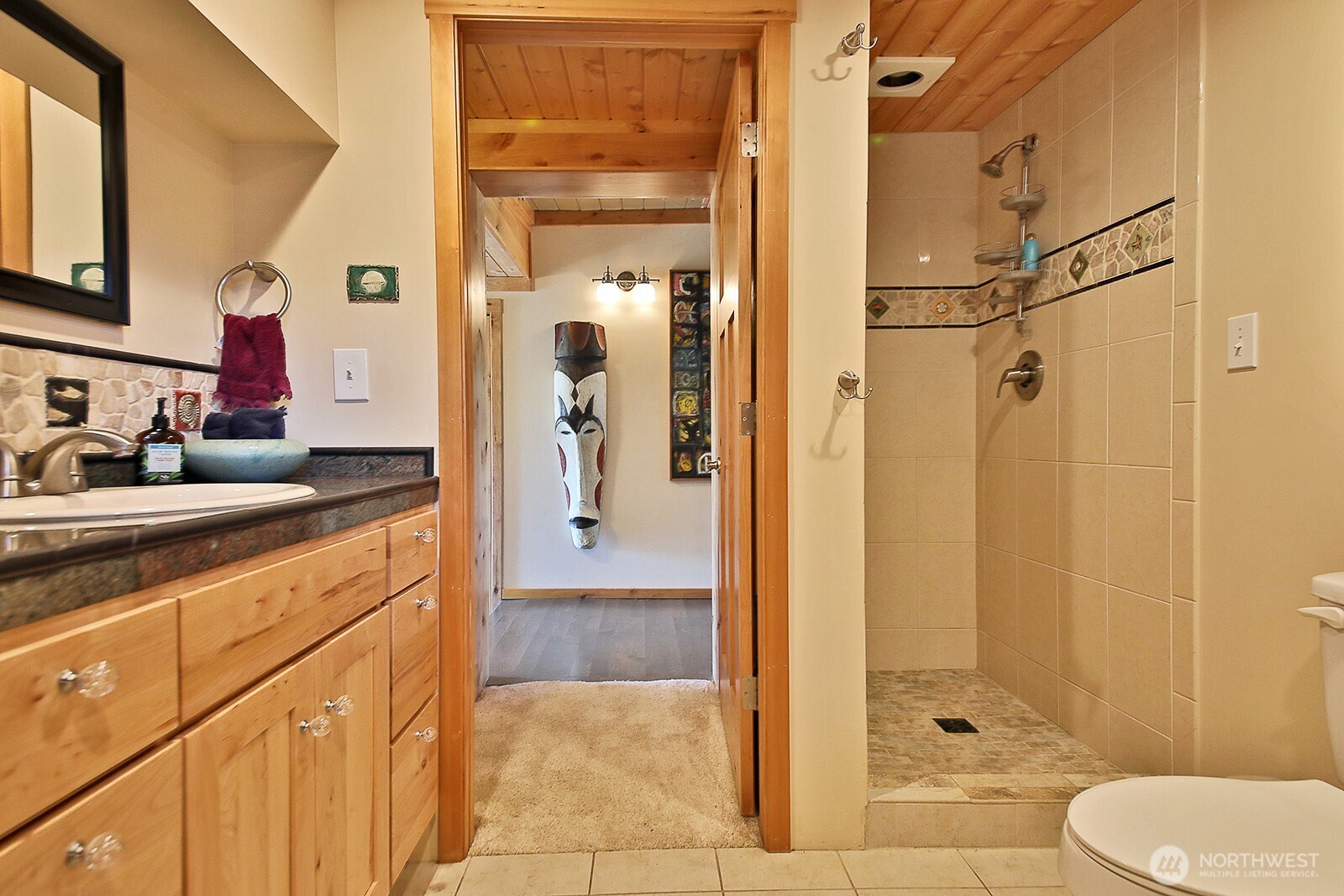 8121 Sandy Hook Terrace Clinton, WA 98236 - Photo 24 of 40 a spacious bathroom with a shower sink and mirror