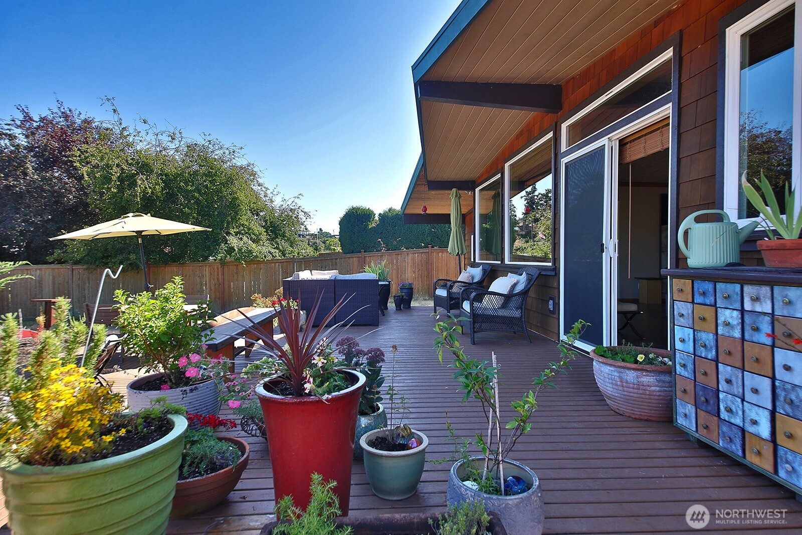 8121 Sandy Hook Terrace Clinton, WA 98236 - Photo 26 of 40 a view of a chairs and table in a patio