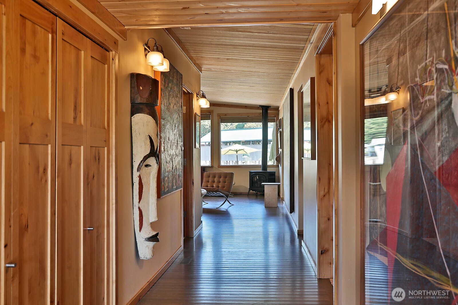 8121 Sandy Hook Terrace Clinton, WA 98236 - Photo 4 of 40 a view of a hallway with wooden floor and furniture