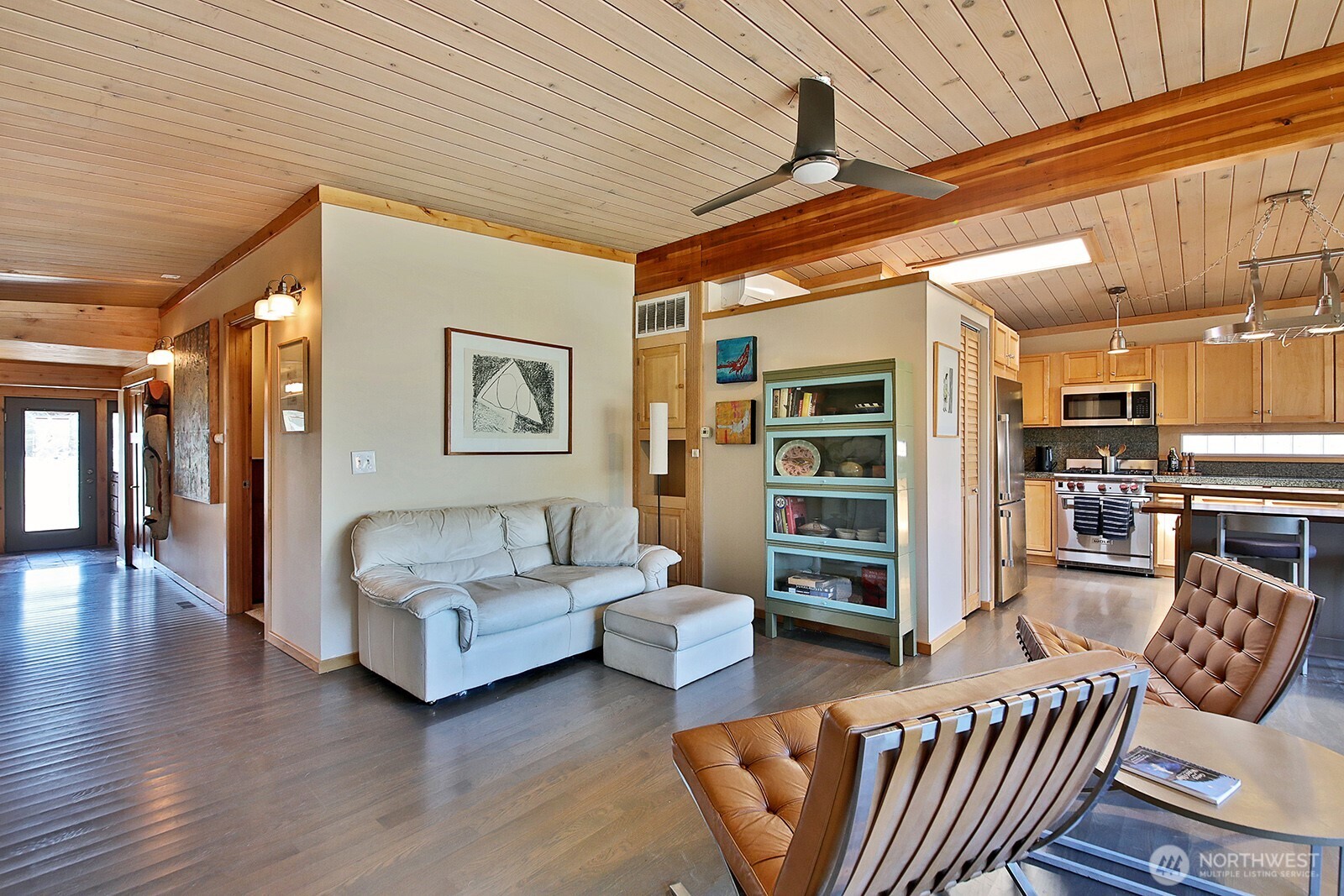 8121 Sandy Hook Terrace Clinton, WA 98236 - Photo 6 of 40 a living room with furniture a ceiling fan and a window