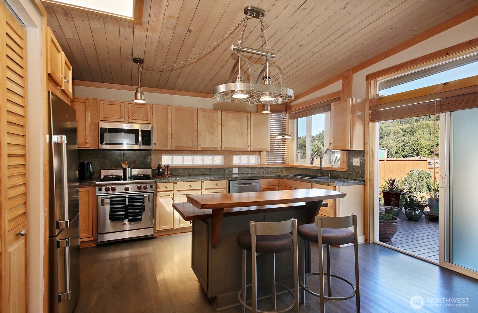 8121 Sandy Hook Terrace Clinton, WA 98236 - Photo 8 of 40 a kitchen with kitchen island a large island in the center and stainless steel appliances