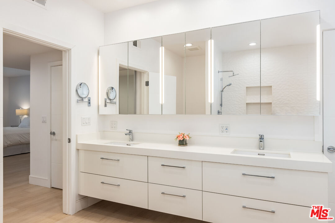 1164 Wellesley Avenue, Unit 101 Los Angeles, CA 90049 - Photo 15 of 25 a bathroom with double sink and a mirror