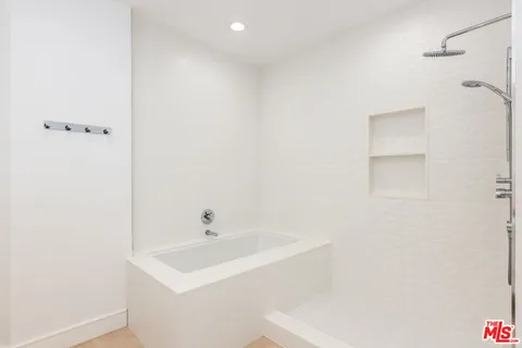 a bathroom with a sink a shower and a mirror