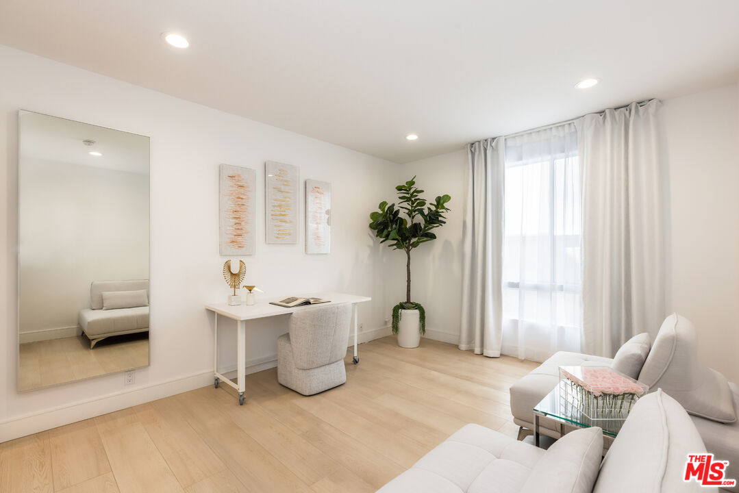1164 Wellesley Avenue, Unit 101 Los Angeles, CA 90049 - Photo 18 of 25 a living room with furniture and a large window