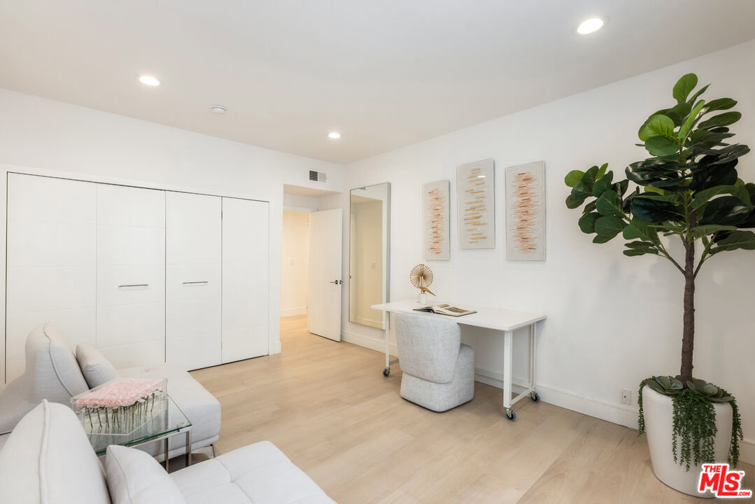 1164 Wellesley Avenue, Unit 101 Los Angeles, CA 90049 - Photo 19 of 25 a living room with furniture a potted plant and a table