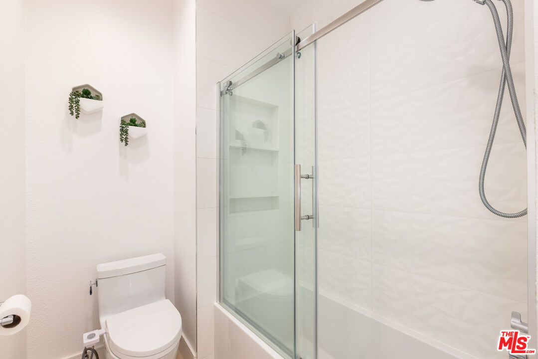 1164 Wellesley Avenue, Unit 101 Los Angeles, CA 90049 - Photo 21 of 25 a bathroom with a toilet and a shower
