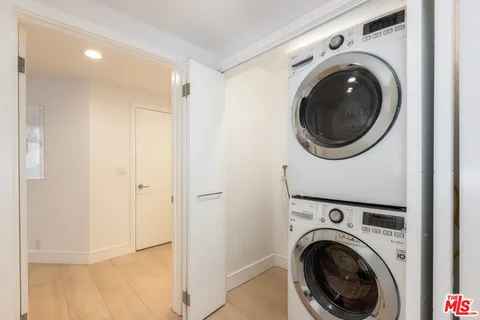 a view of a hallway with washer and dryer