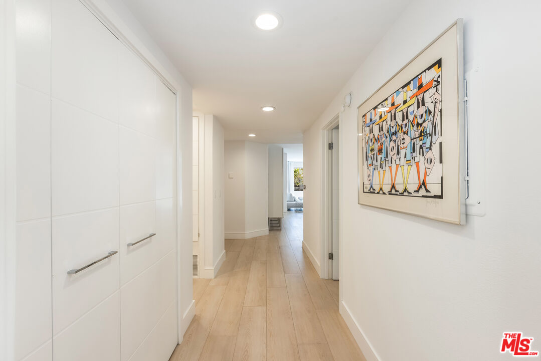 1164 Wellesley Avenue, Unit 101 Los Angeles, CA 90049 - Photo 23 of 25 a view of a hallway with wooden floor and closet