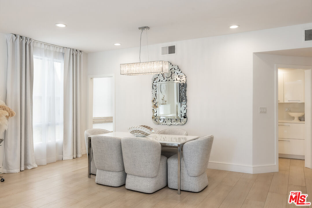 1164 Wellesley Avenue, Unit 101 Los Angeles, CA 90049 - Photo 3 of 25 a bathroom with a sink a mirror and a shower