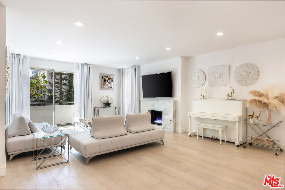 1164 Wellesley Avenue, Unit 101 Los Angeles, CA 90049 - Photo 5 of 25 a living room with furniture and a flat screen tv