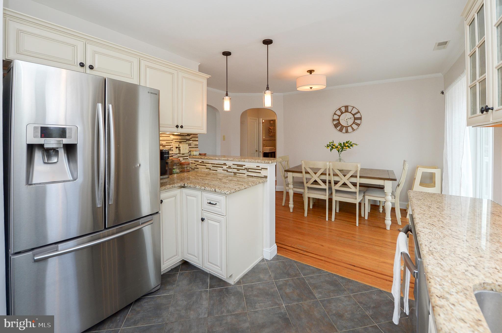 1929 Wayne Avenue Haddon Heights, NJ 08035 - Photo 8 of 36 a kitchen with stainless steel appliances kitchen island granite countertop dining table chairs and a refrigerator
